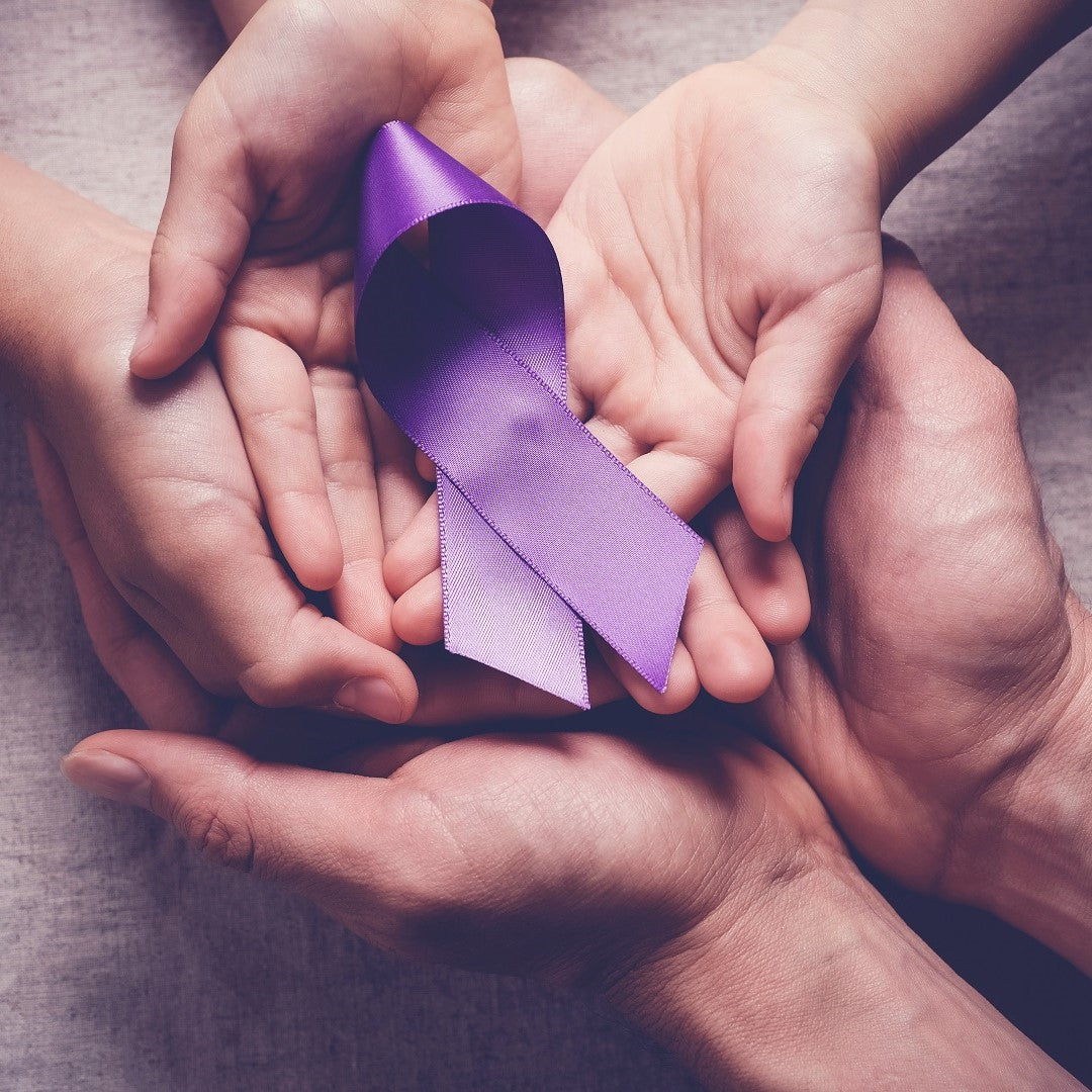 Adults and children holding purple ribbons, National Cancer Survivor's Day 2023
